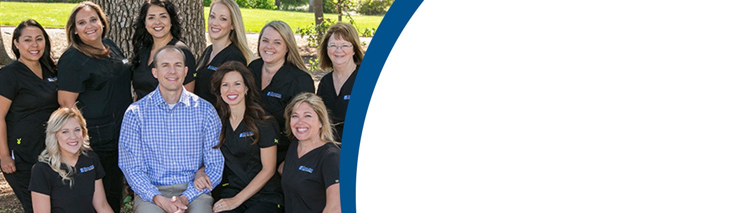 Dr. Christian Hoybjerg smiling for a group photo with the staff at Hoybjerg Family Orthodontics.